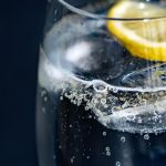 close up of a glass of water with a lemon slice