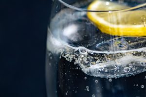 close up of a glass of water with a lemon slice