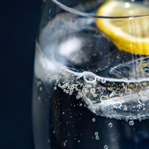 close up of a glass of water with a lemon slice